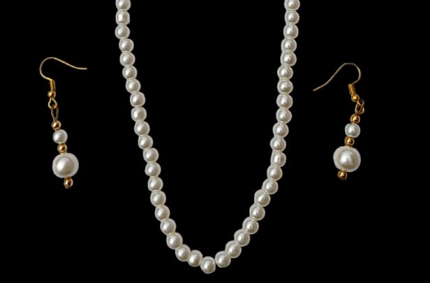 White pearl necklace and matching pearl drop earrings with gold hooks